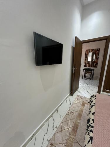 a flat screen tv on the wall of a bedroom at Magnificent Cozy New Luxury Condo in Prime Casablanca Location in Les Camps
