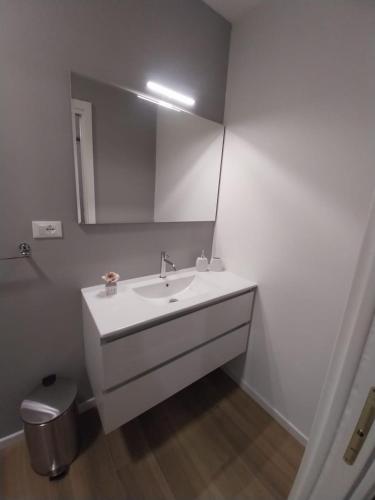 a bathroom with a white sink and a mirror at B&B Regina in Ravenna