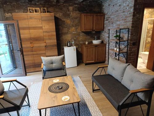 a living room with a wooden table and chairs at Taş Evler Butik Otel in Sirince