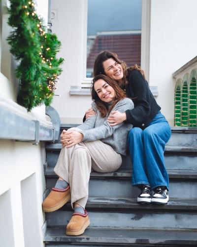 two women sitting on the steps of a house at Stella Suites Boutique Hotel in Goirle