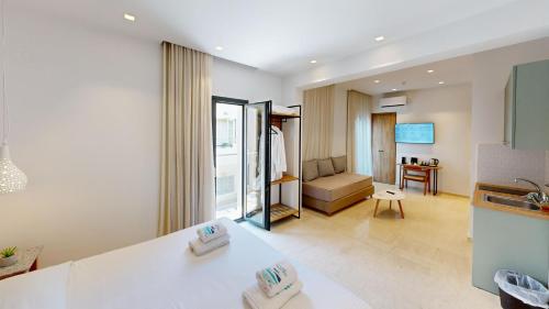 a kitchen and living room with a sink and a couch at Maritime Suites in Hersonissos