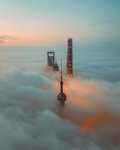 a view of skyscrapers above the clouds in a city at Dayin Youth Hostel - Old Town & People's Square& Rail Hub -Social Area -Bar -Café -Gym -Free Laundry Luggage Storage -24H Front Desk -English Service in Shanghai