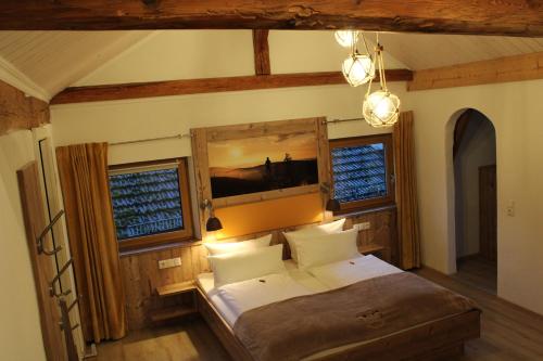 a bedroom with a bed and two windows at Bayerische Gastwirtschaft Dimpfl-Stadl in Lam