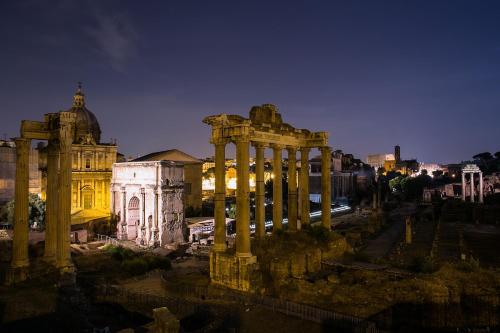 a lit up city at night with a building at Guest House Grazioli in Rome