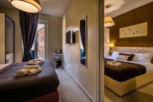 a bedroom with two beds with towels on them at Guest House Grazioli in Rome