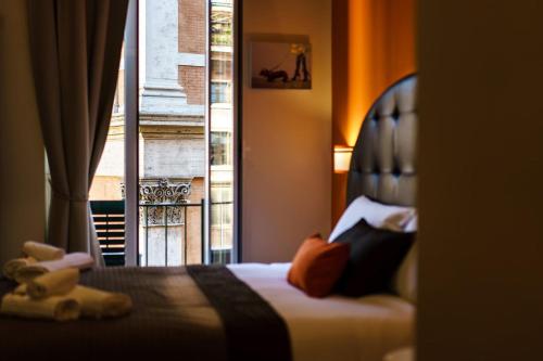 a bedroom with a bed with a large window at Guest House Grazioli in Rome
