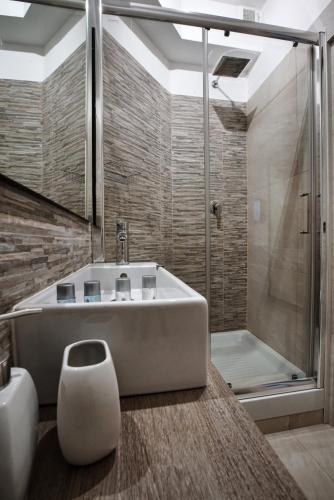 a bathroom with a large tub and a shower at Guest House Grazioli in Rome