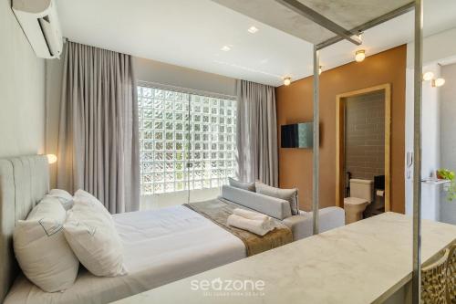 a hotel room with a bed and a window at Lindo Estúdio Funcional em Goiânia SLV0011 in Goiânia