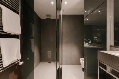 a bathroom with a shower and a toilet and a sink at BoHo Hotel Budapest - Small Luxury Hotels in Budapest