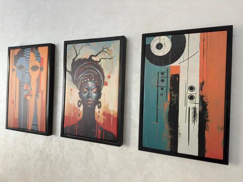 three framed paintings of a woman on a wall at Magnificent Cozy New Luxury Condo in Prime Casablanca Location in Les Camps