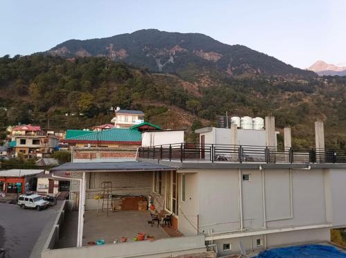 a view of a building with a mountain in the background at The Crown in Dharamshala