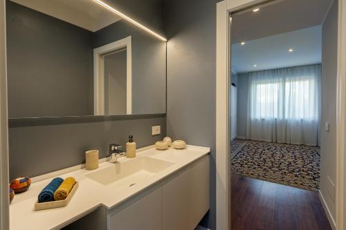 a bathroom with a white sink and a mirror at Villa Ceratti in Cassano Magnago