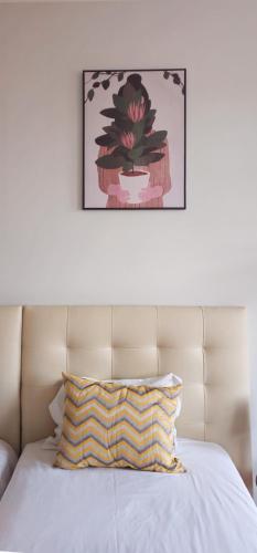 a bed with a pillow and a picture on the wall at Santa Maria Hostel in Funchal