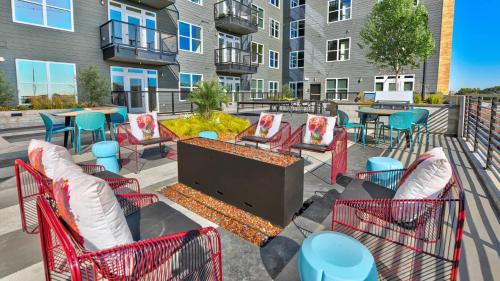 a patio with chairs and a television and tables at Indie Deep Ellum in Dallas in Dallas