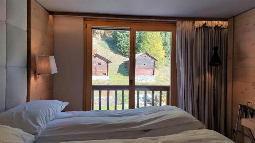 Postel nebo postele na pokoji v ubytování Chandolin Boutique Hotel