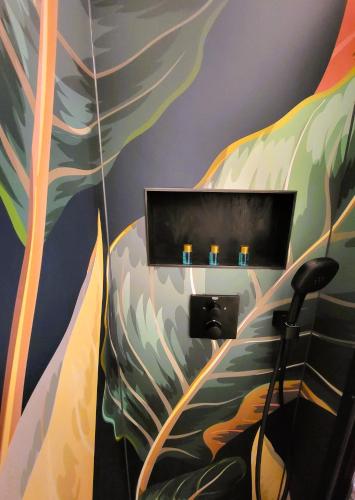 a room with a wall with a mural of leaves at Hotelwohnung Superior-Suite in Beatenberg