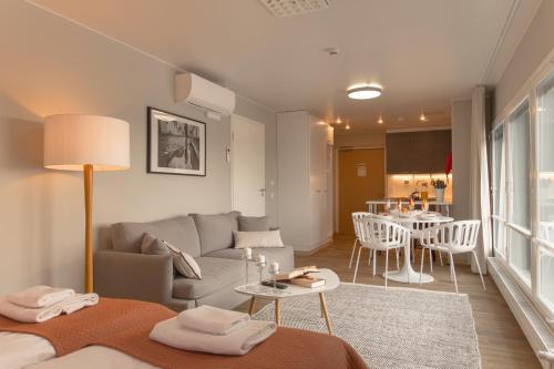 a living room with a couch and a table at Forenom Aparthotel Espoo Leppävaara in Espoo