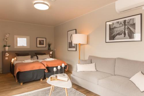 a living room with a bed and a couch at Forenom Aparthotel Espoo Leppävaara in Espoo