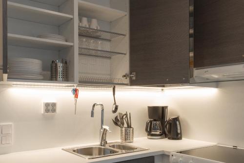 a kitchen with a sink and a counter top at Forenom Aparthotel Espoo Leppävaara in Espoo