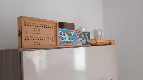 a counter with a box on top of a refrigerator at Casa Temporada Poços de Caldas in Poços de Caldas