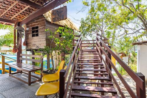 a staircase leading to a patio with chairs and a table at Casa c/ Piscina-4 Quartos-Barra de Catuama-SH101M in Ponta do Funil