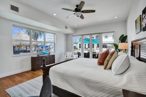 a bedroom with a large bed with a ceiling fan at Villa Horizon - Stunning waterfront villa in Boca Raton in Boca Raton