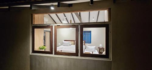 a reflection of a bedroom in a window at Cinta Hiriketiya in Dickwella