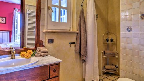a bathroom with a sink and a window and a shower at VILLA IPAZIA 6, Emma Villas in Sonnino