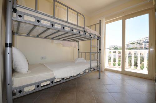a bedroom with two bunk beds and a large window at Villa Romantica 17 in Milas