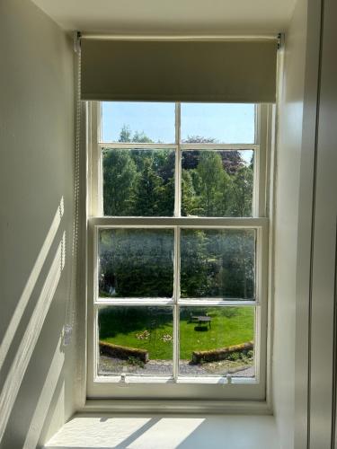 a window in a room with a view of a yard at Estate Of Ord in Muir of Ord