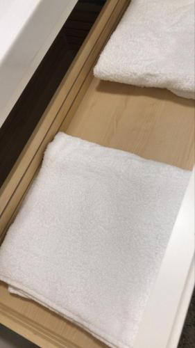 a pile of white towels sitting on top of a table at 2 bedroom apartment at Knokke-Heist, near Zeebrugge, overlooking the lake in Knokke-Heist