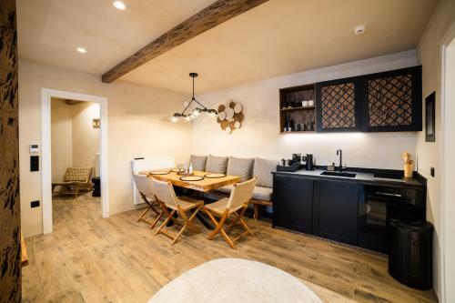 a kitchen and dining room with a table and chairs at Maison Michelangelo in Arachova