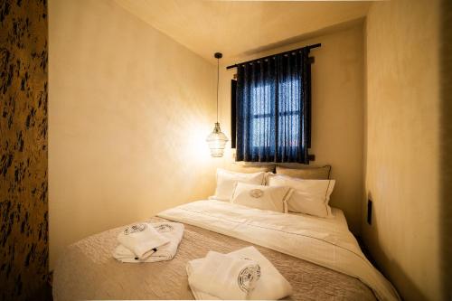a bedroom with a bed with towels on it at Maison Michelangelo in Arachova