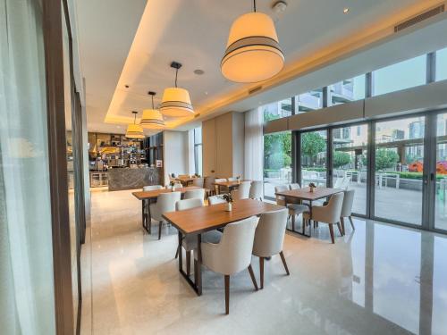 a restaurant with tables and chairs and windows at Address Residence Opera, Downtown, Dubai in Dubai