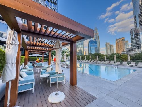 a patio with chairs and a pool in a city at Address Residence Opera, Downtown, Dubai in Dubai