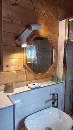 a bathroom with a sink and a mirror at Chalet Siebenschläfer in Hohentauern