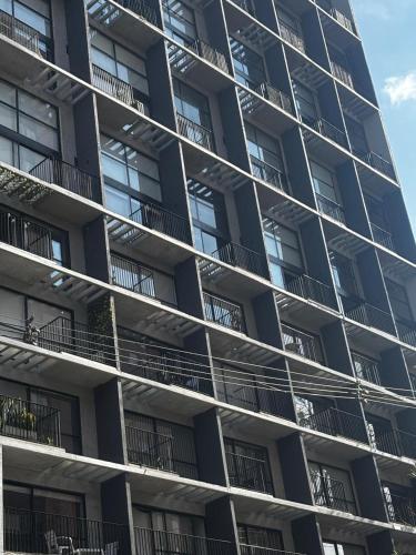 a tall apartment building with balconies on it at Encantador Loft urbano en el corazón de Medellín in Medellín