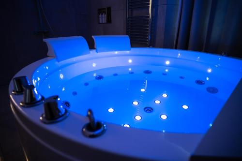 a blue tub with two chairs in a room at Enjoyhousebracciano suite2 in Bracciano