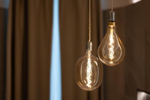 three glass bulbs are hanging from a ceiling at Enjoyhousebracciano suite2 in Bracciano