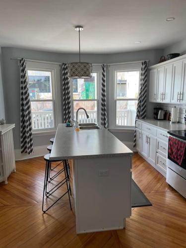 a kitchen with a sink and a counter top at 86A King Bed 2bd 3bt on Queen St. Downtown in Charlottetown