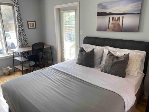 a bedroom with a large white bed with pillows at 86A King Bed 2bd 3bt on Queen St. Downtown in Charlottetown