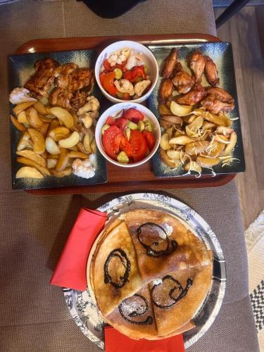 a table with two trays of food and a plate of food at CABANA 365 in Braşov