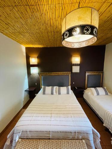 Кровать или кровати в номере Hotel Refugio Del Sol
