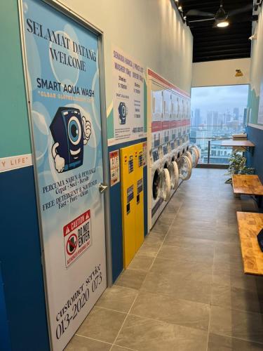 a hallway with signs on the walls of a store at 24h Check in & SkyPool- KL Sentral Suite Riveria City Near KL Sentral KL KLCC in Kuala Lumpur
