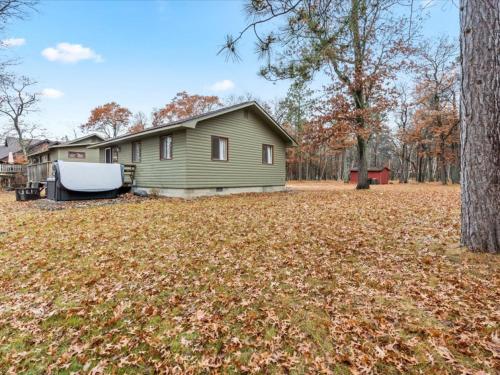 a house with a gazebo in a yard at Cute Whitefish Cabin with Hot tub in Cross Lake