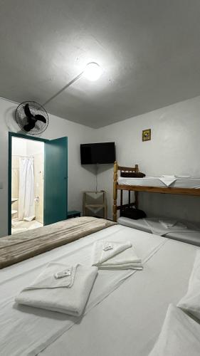 a bedroom with a large bed with a mirror at Pousada Manjericão in Paraty