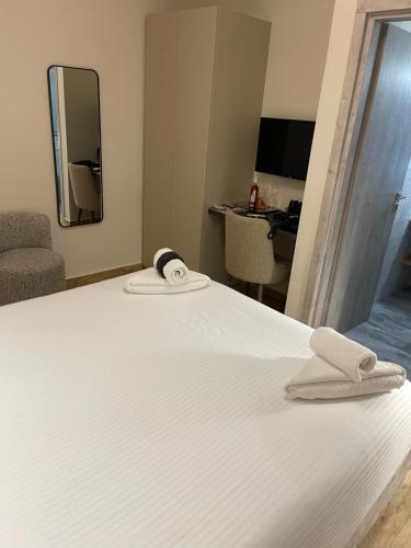 a bedroom with a bed with two towels on it at Terra Di Pietra Exclusive Suites & Apartments in Areopolis