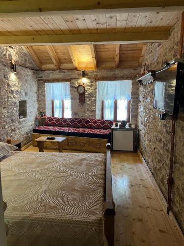 a bedroom with a large bed in a stone building at Old Room Bazaar in Gjirokastër
