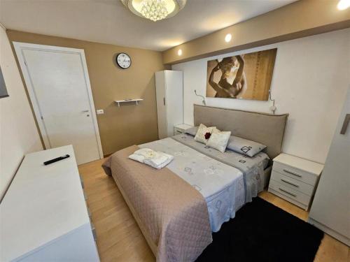 a bedroom with a bed and a clock on the wall at beb Acqua Dolce in Taurisano