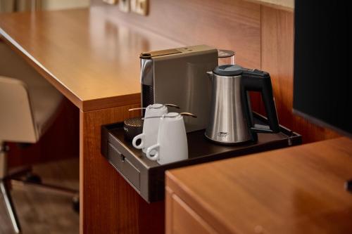 a coffeemaker sitting on a counter with a coffee maker at Crowne Plaza Maastricht by IHG in Maastricht